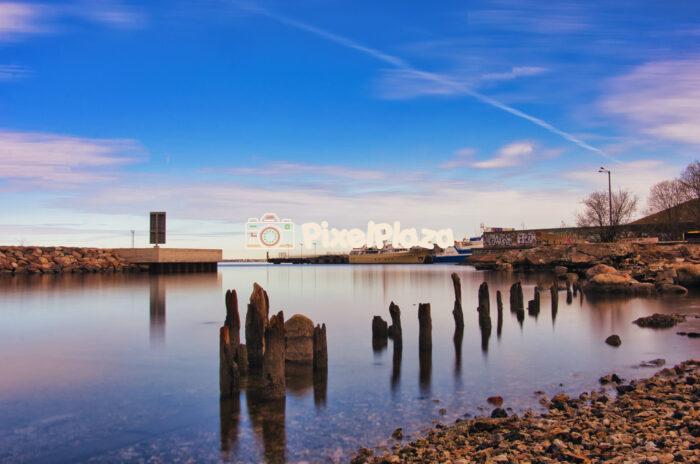 Serene Harbor with Wooden Pilings at Sunset