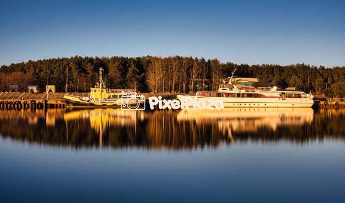 Tranquil Harbor Scene with Ships and Reflections