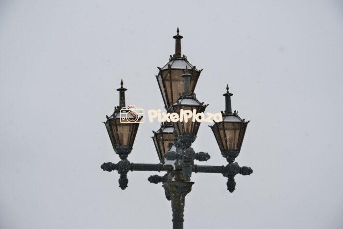 Vintage street lamp with snowfall