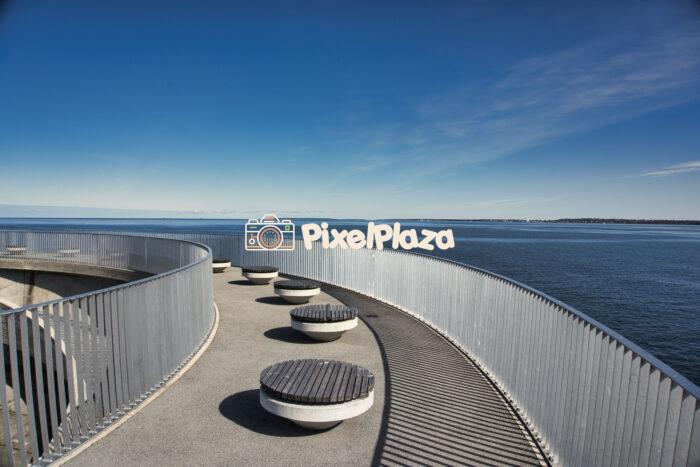 Modern Seaside Promenade with Circular Benches and Sea View