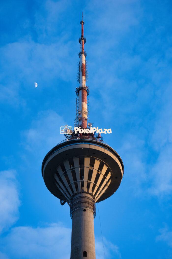 Tallinn TV Tower Against Blue Sky with Moon