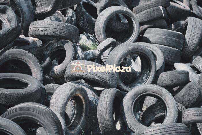 Discarded Used Car Tires in a Junkyard Discarded Used Car Tires in a Junkyard