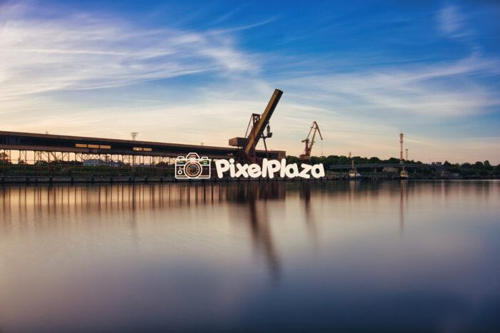 Industrial Port of Ventspils, Latvia at Sunset - Tranquil Waters and Cranes
