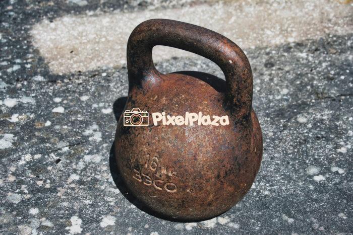 Rusty Old Kettlebell on Concrete Surface
