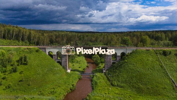 Scenic Railway Bridge Over Rauna River in Latvia - Aerial Landscape View