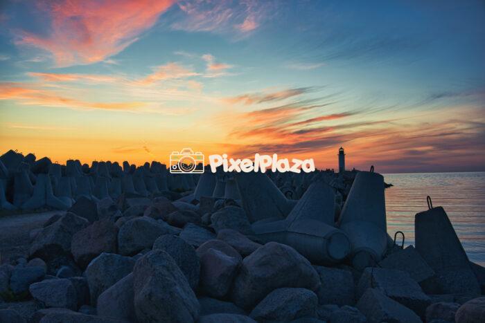 Sunset at Ventspils Pier, Latvia - Lighthouse on Baltic Sea Coast Sunset at Ventspils Pier, Latvia - Lighthouse on Baltic Sea Coast