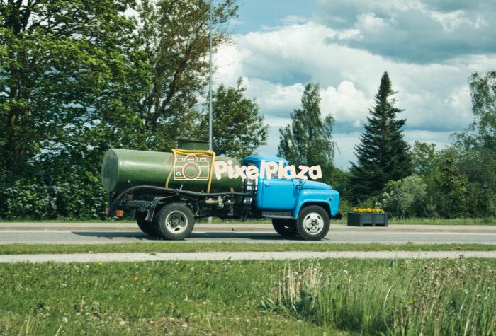 Vintage Classic Soviet-era Blue Truck GAZ-53 with Green Tank on Countryside Road2 Vintage Classic Soviet-era Blue Truck GAZ-53 with Green Tank on Countryside Road