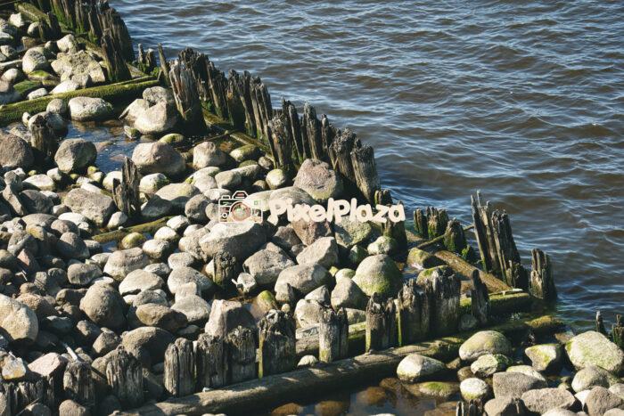 Wooden Pier and Coastal Rocks by the Shoreline