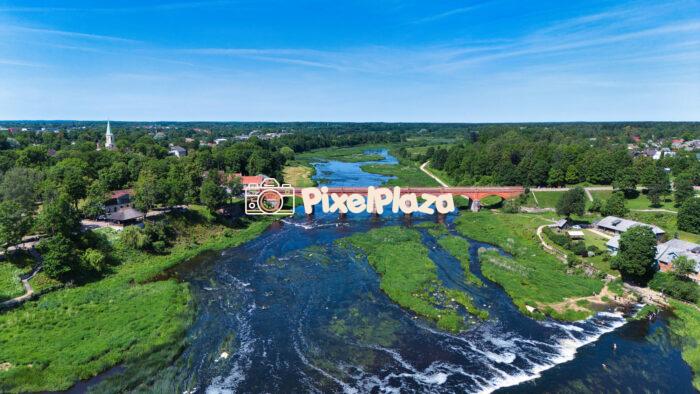 Aerial View of Kuldīga and Historic Red Brick Bridge Over Venta River - Latvia Summer Landscape