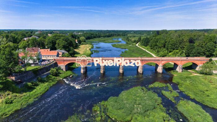 Drone Shot of Kuldīga’s Iconic Red Brick Bridge Over Venta River - Latvia’s Hidden Gem
