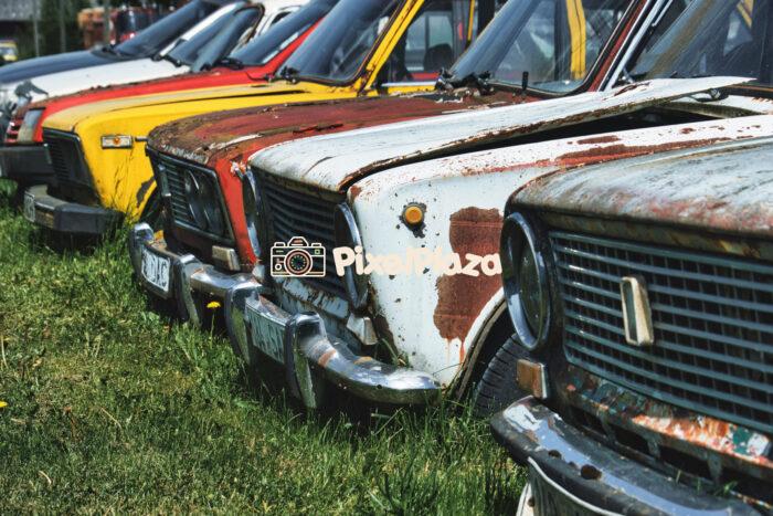 Lineup of Rusty Classic Lada Cars in Abandoned Field - Retro Soviet Vehicles Lineup of Rusty Classic Lada Cars in Abandoned Field - Retro Soviet Vehicles