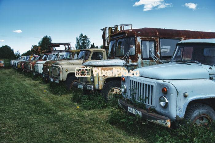 Row of Abandoned Soviet Trucks in Rural Field - Rusty Vintage Vehicles Outdoors