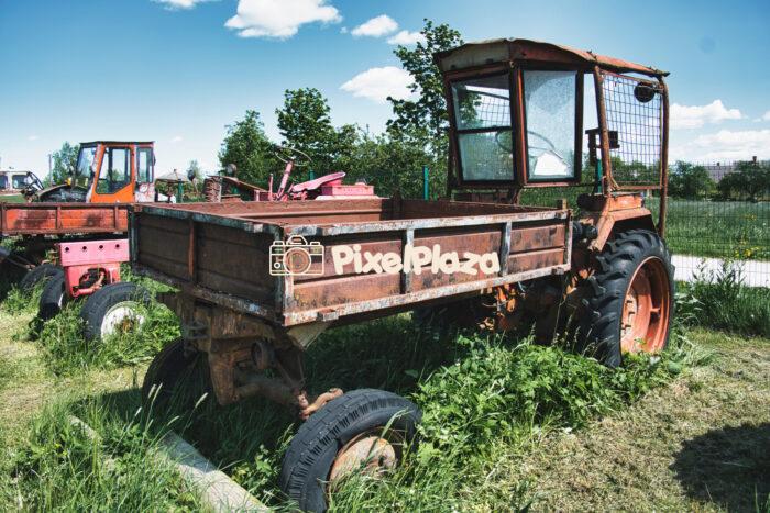 Rusty Abandoned Farm Tractor in Overgrown Grass - Rural Summer Scene Rusty Abandoned Farm Tractor in Overgrown Grass - Rural Summer Scene