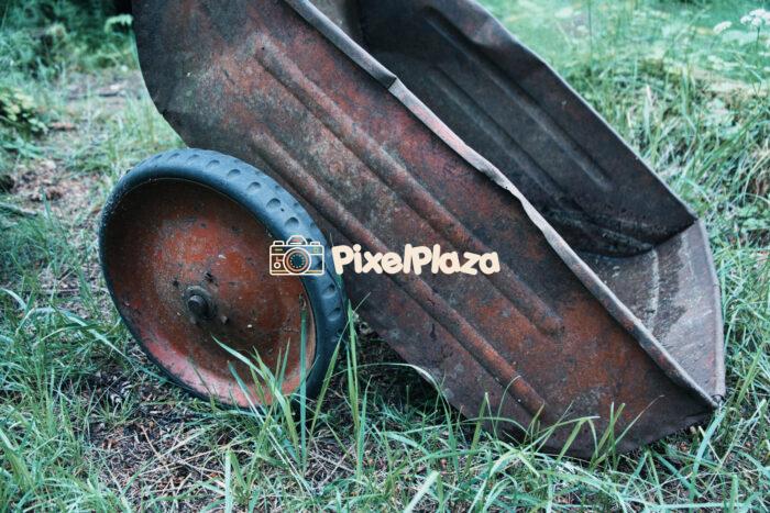 Rusty Old Garden Cart in Overgrown Grass Rusty Old Garden Cart in Overgrown Grass