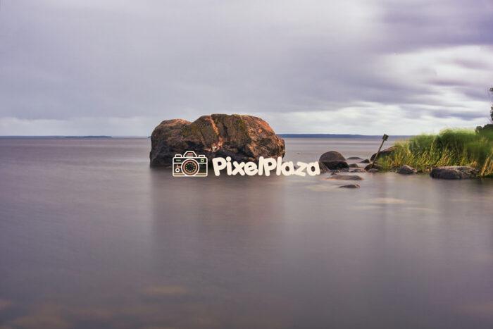 Tranquil Baltic Seashore with Large Boulder and Cloudy Sky - Estonia Nature Landscape