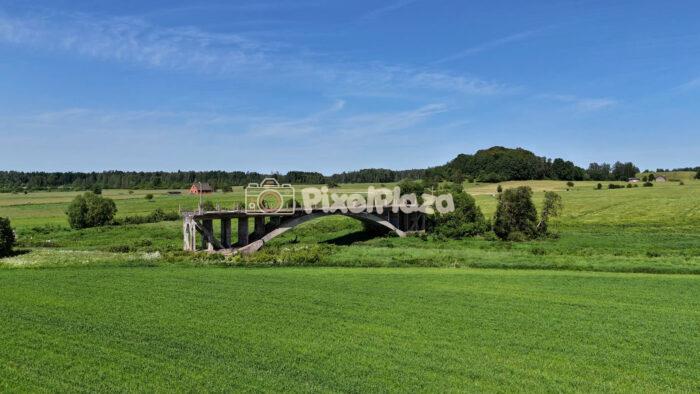 Aerial Drone Video of Abandoned Bridge in Sāti, Latvia - Scenic Rural Countryside and River Views