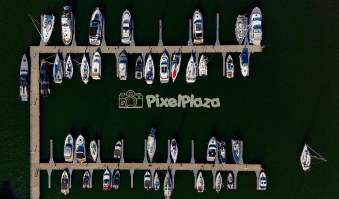 Drone View of Yacht Marina with Sailboats - Scenic Aerial Harbor Perspective Drone View of Yacht Marina with Sailboats - Scenic Aerial Harbor Perspective