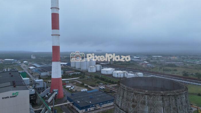 Foggy Industrial Landscape with Power Plant and Storage Tanks in Tallinn - Aerial Drone View