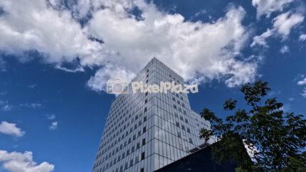 Timelapse of a modern glass house under a summer sky in Tallinn, Estonia