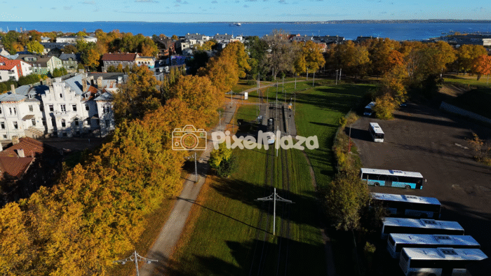 Aerial Drone View of Tallinn City Tram and Autumn Park Near Seaside - Scenic Urban Landscape