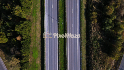 Aerial Drone View of Highway Through Forest Landscape - 4K Drone Video