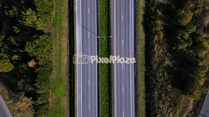 Aerial Drone View of Highway Through Forest Landscape - 4K Drone Video