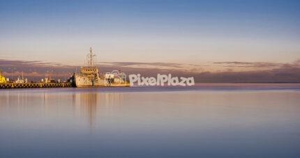 Long Exposure of Naval Ship at Harbour During Pastel Sunset