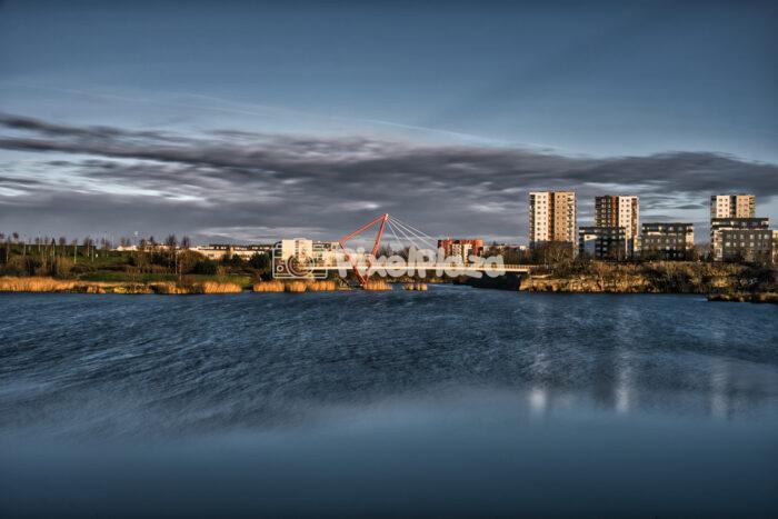 Red Suspension Bridge Over Pae Lake at Sunset with Long Exposure Water Effect