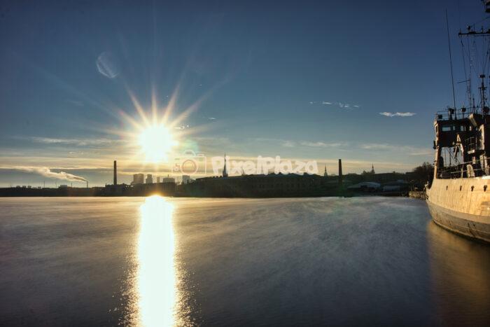 Sunburst Over Tallinn Industrial Skyline and Port at Long Exposure Sunrise