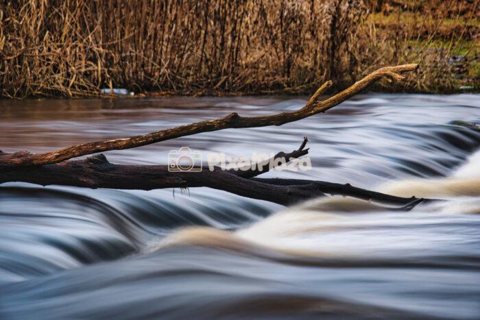 Ethereal Long Exposure of Vahiküla Waterfall Cascading Through the Estonian Wilderness