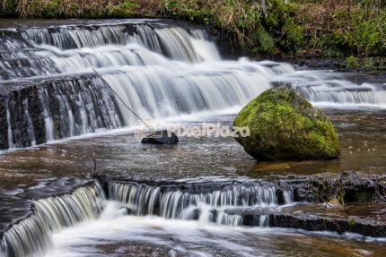 Mossy Boulder in the Silky Cascades of Treppoja Waterfall, Estonia