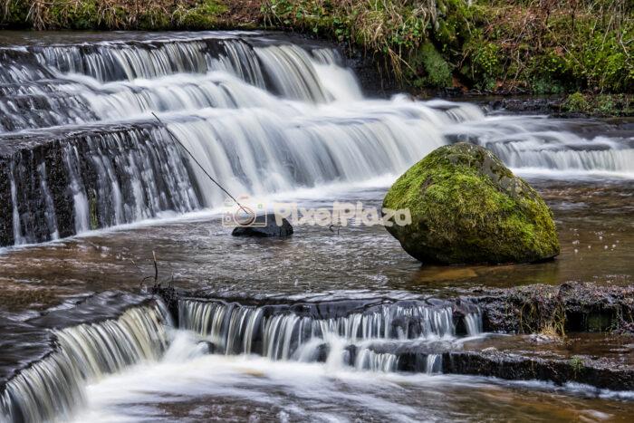 Mossy Boulder in the Silky Cascades of Treppoja Waterfall, Estonia