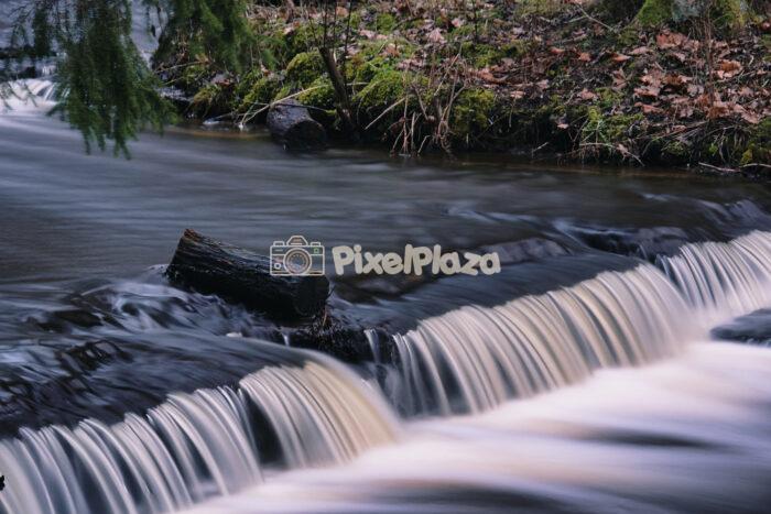 Serene Treppoja Waterfall in Lush Estonian Forest Landscape