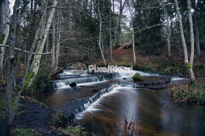 Wide Landscape of the Tiered Treppoja Waterfall in Estonian Forest Wide Landscape of the Tiered Treppoja Waterfall in Estonian Forest