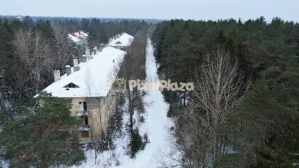 Winter Aerial View of Snowy Residential Buildings and Forest in Estonia - 4K Drone Video