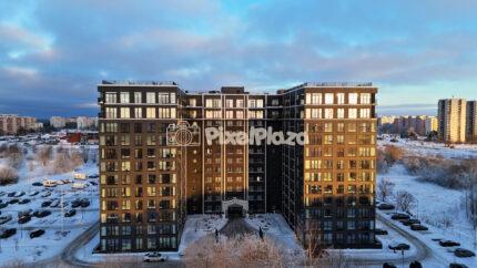 Aerial Drone View of Modern Apartment Buildings in Snowy Tallinn at Winter Sunset