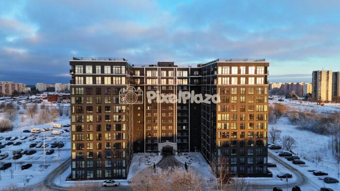 Aerial Drone View of Modern Apartment Buildings in Snowy Tallinn at Winter Sunset