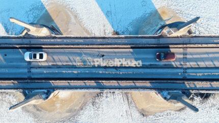 Top Down Aerial of Pärnu City Center Bridge in Winter - Estonia Traffic Drone View