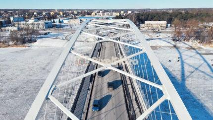 Winter Aerial Over Pärnu Arch Bridge - Snowy Urban Traffic in Estonia
