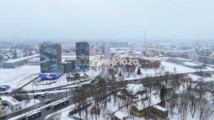 Winter Aerial View of Hipodroomi District, Tallinn Cityscape with Snowy Roads and Modern Buildings