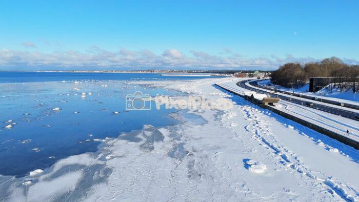 Winter Coastal Road and Frozen Baltic Sea Aerial - Pirita Road, Tallinn, Estonia