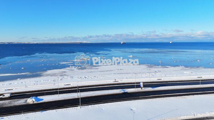 Winter Drone Aerial of Icy Baltic Sea and Pirita Road Coastline in Tallinn, Estonia