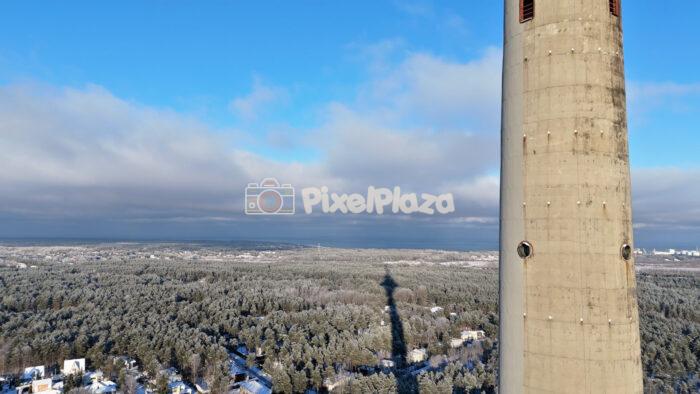 Winter Drone Aerial of Tallinn TV Tower Above Snowy Forest Landscape, Estonia