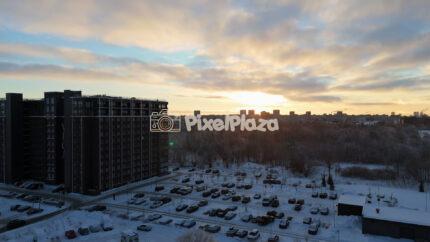 Winter Sunset Aerial Over Tallinn Residential District - Snowy Cityscape Drone View