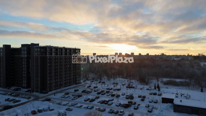 Winter Sunset Aerial Over Tallinn Residential District - Snowy Cityscape Drone View