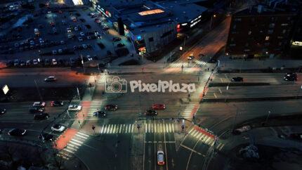 Aerial Drone View of Busy Night Intersection in Tallinn City with Traffic and Urban Lights