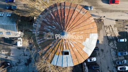 Aerial Top-Down View of Circular Industrial Roof in Telliskivi Creative Quarter, Tallinn, Estonia