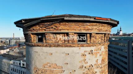 Drone Close-Up of Historic Round Brick Water Tower in Telliskivi Creative Quarter, Tallinn, Estonia