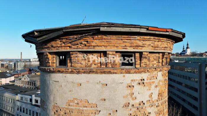 Drone Close-Up of Historic Round Brick Water Tower in Telliskivi Creative Quarter, Tallinn, Estonia