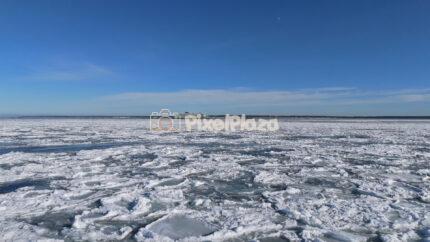 Drone Flying Over Frozen Baltic Sea Toward Passenger Ferry near Paljassaare, Tallinn, Estonia